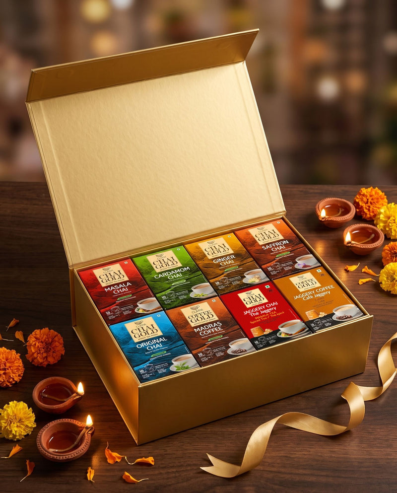 Chai Gold Diwali gift box: open gold magnetic box holding 8 Chai Gold and Coffee Gold 10-sachet boxes, with diyas and marigolds